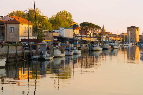 Golden Hour on Cervia Channel – Tower Reflections in Warm Light